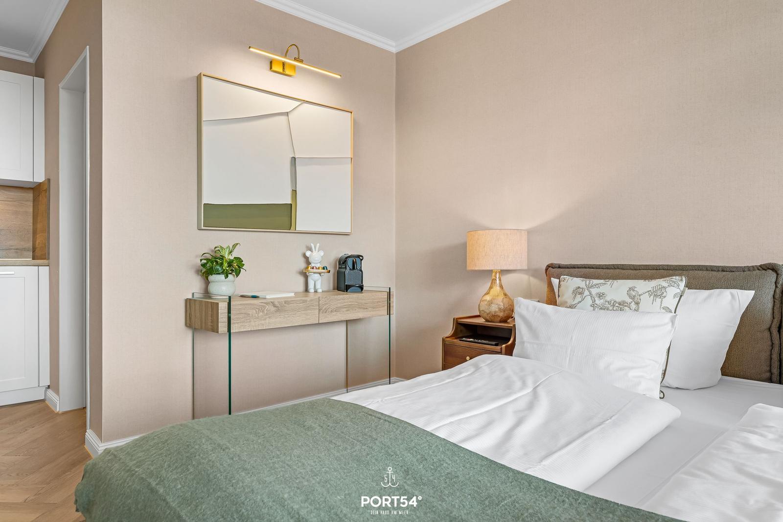 Bedroom with bed, nightstand, and mirror cabinet