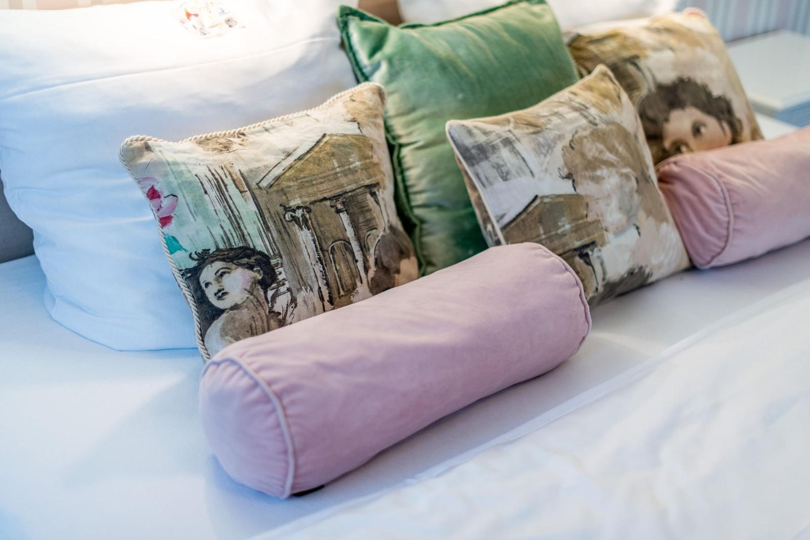 Headboard with pillows in various colors and patterns.