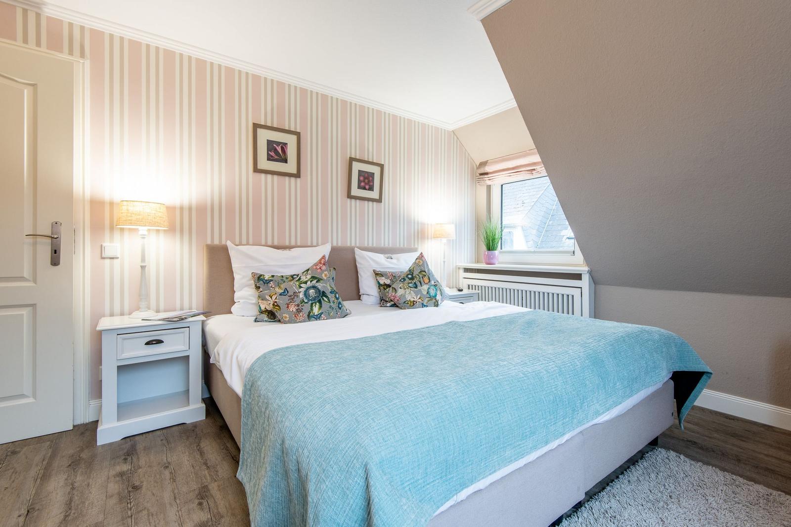 Bedroom with bed, nightstand, and window