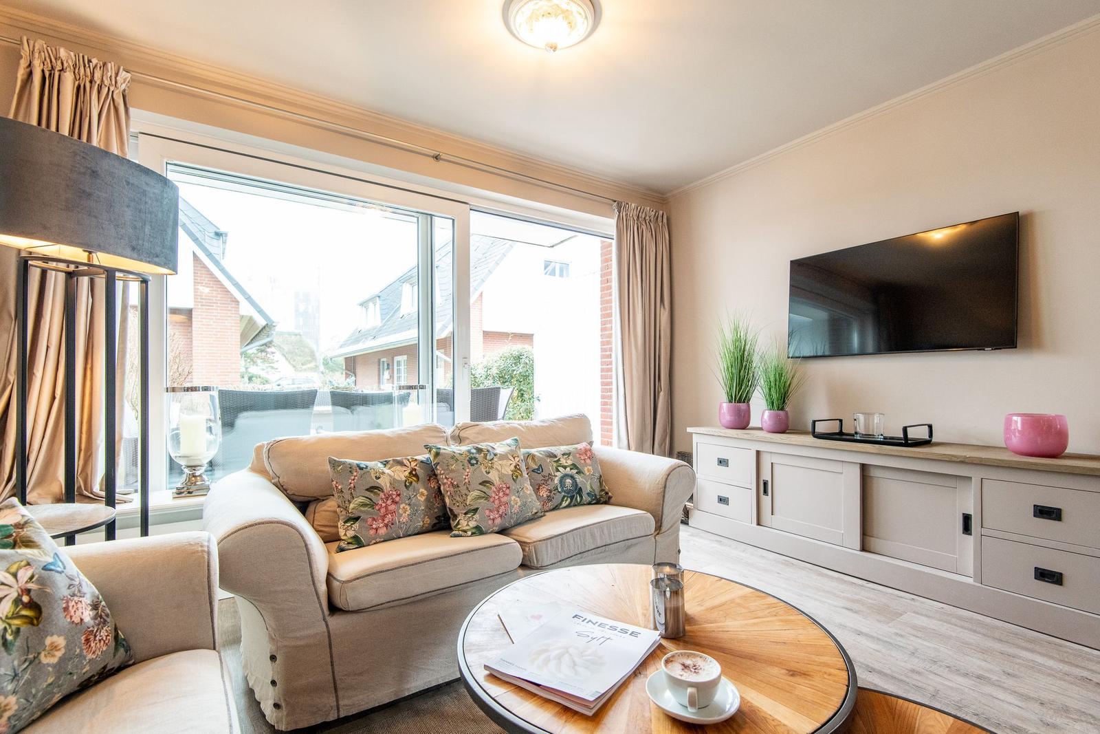 Living room with sofa, TV, and round table
