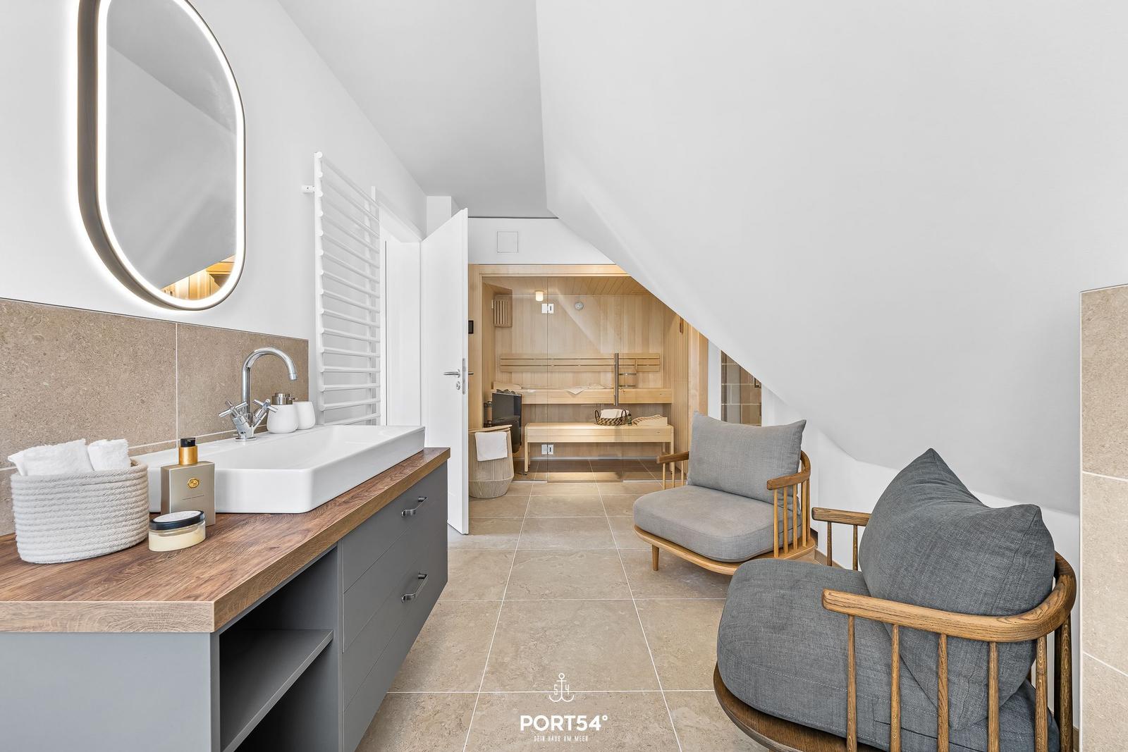 Bathroom with sauna, sink, and seating areas.