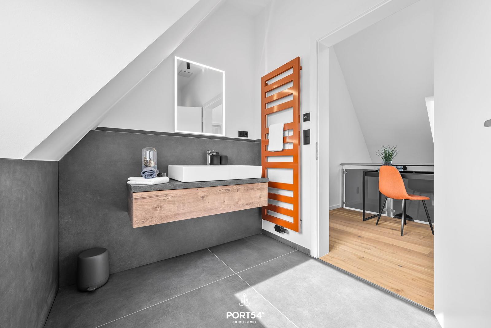 Bathroom with shower, mirror cabinet, and orange heater.
