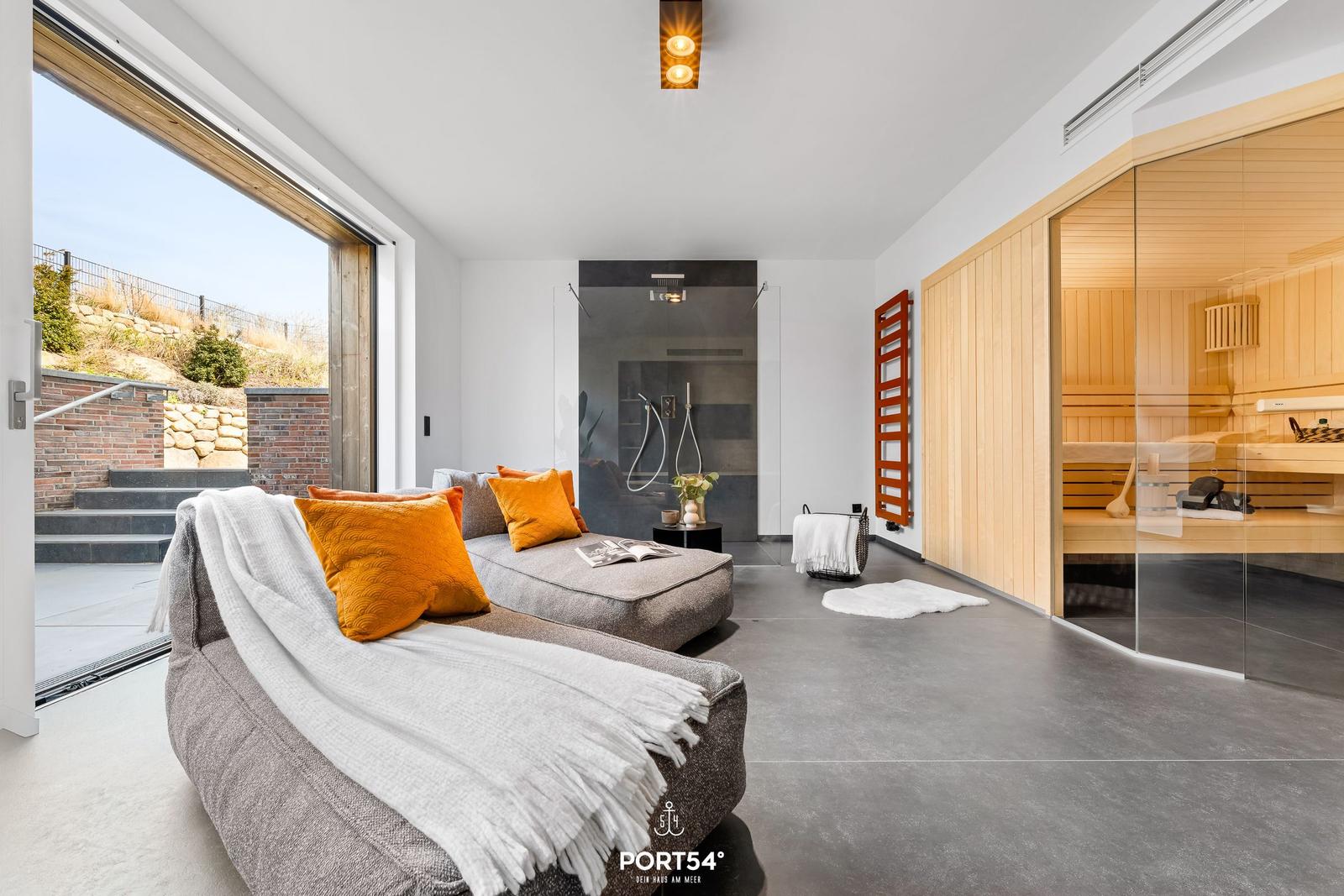 Lounge with sauna and shower. Large glass front to terrace.