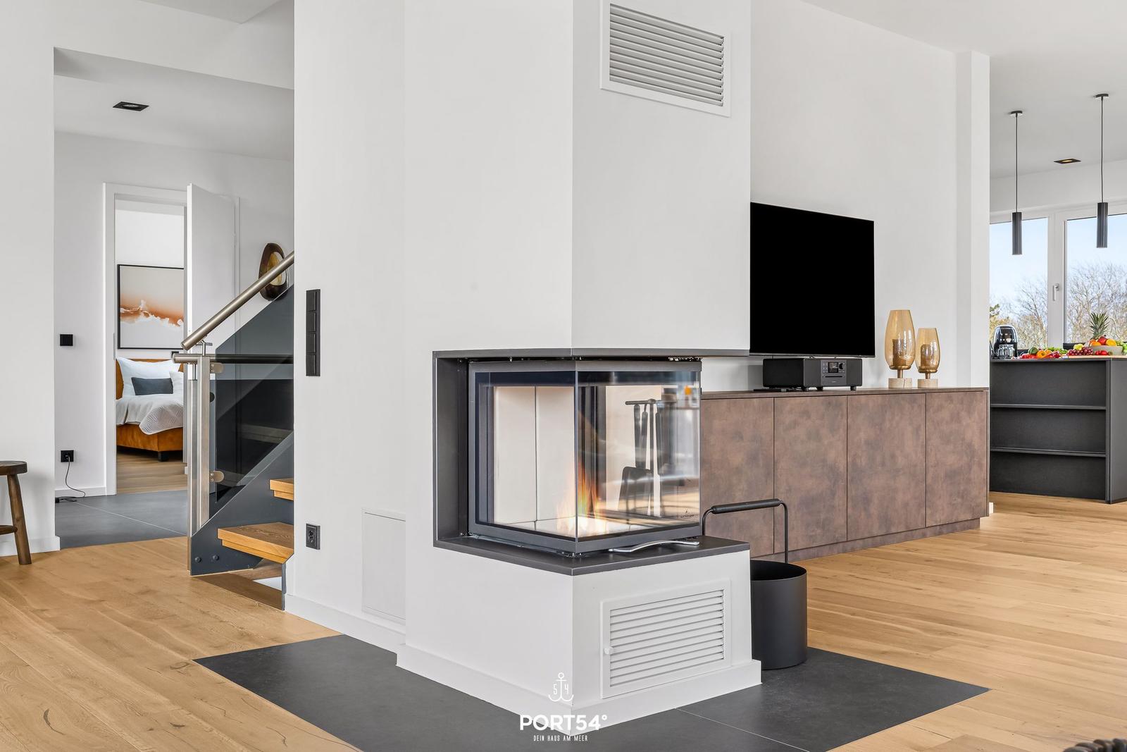 Living area with fireplace, TV, and view into bedroom