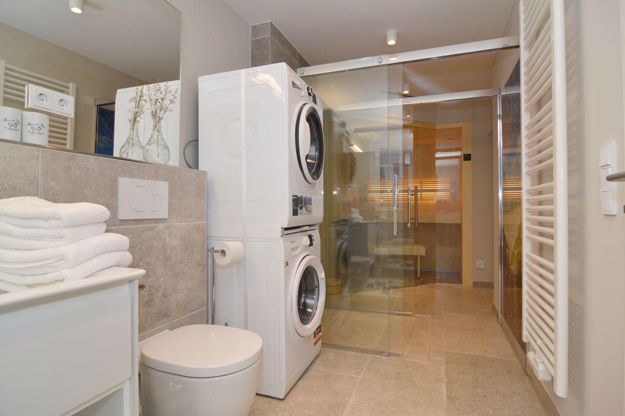 Bathroom with washing machine, dryer, and shower