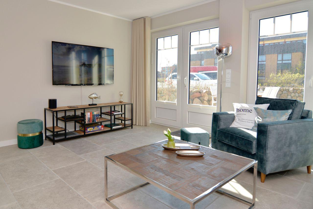 Living room with sofa, TV, and large window.