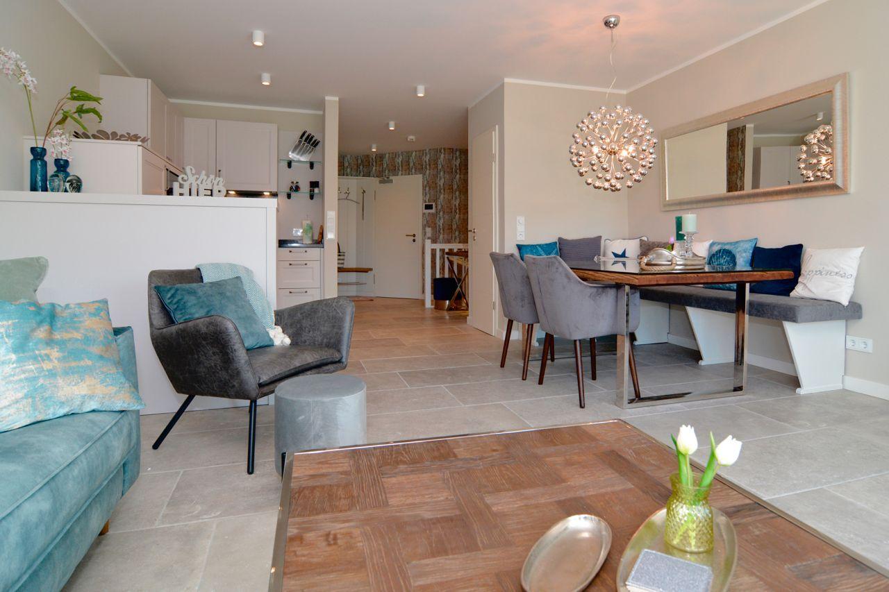 Living and dining area with modern furniture and wooden floor.