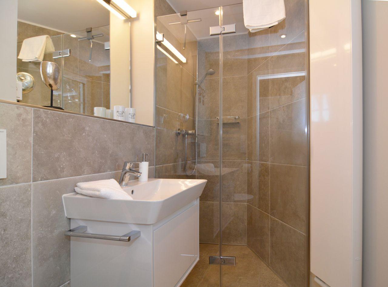 Bathroom with shower, sink and mirror