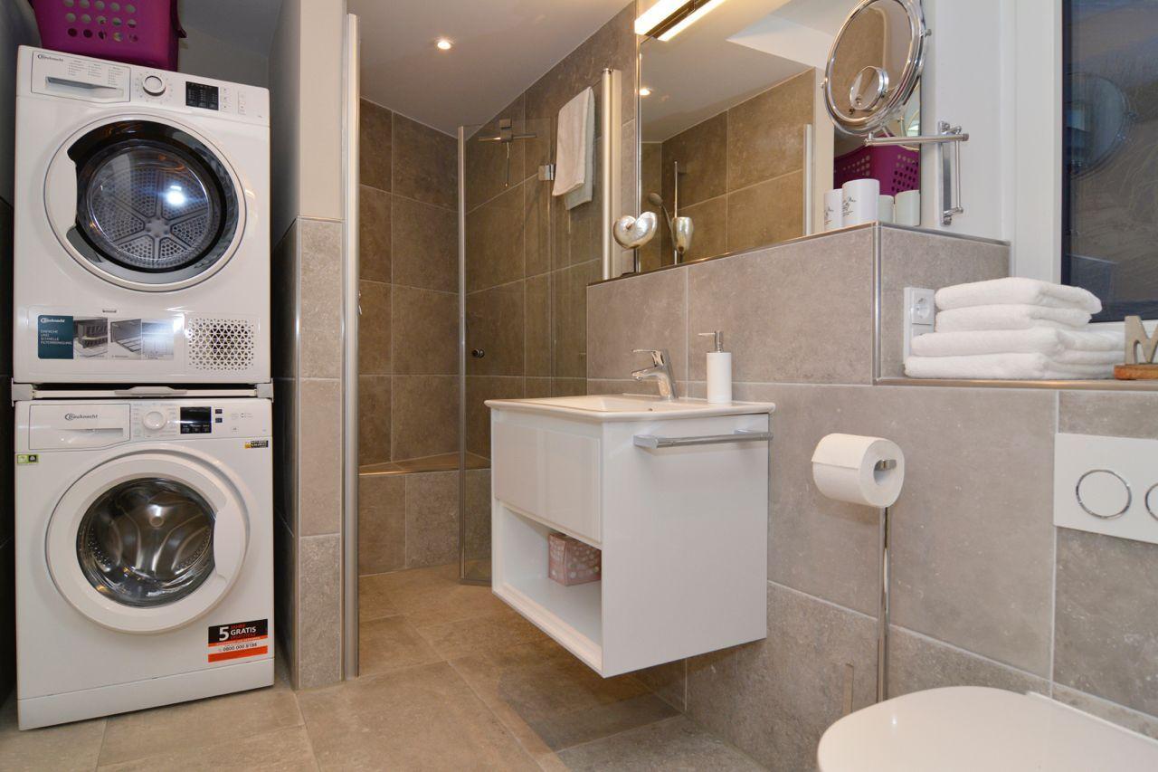 Bathroom with shower, sink, and washing machine