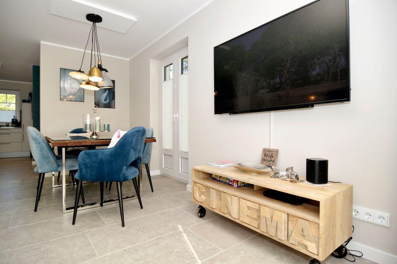 Living and dining area with TV and dining table.