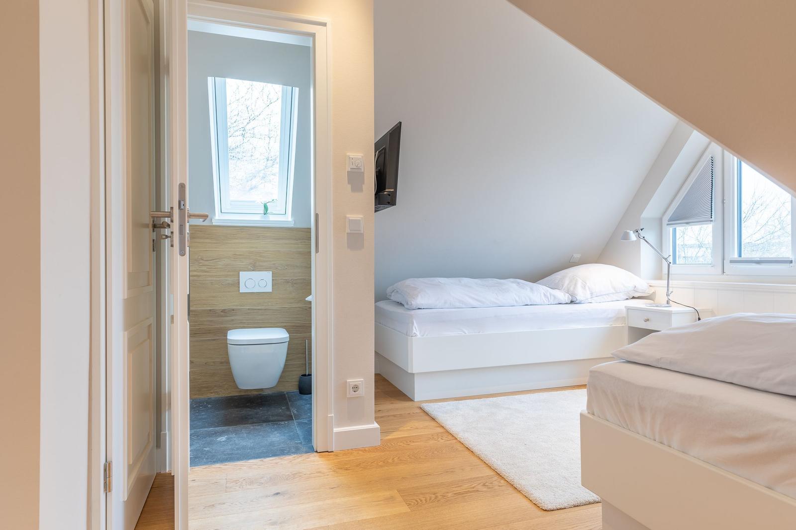 Room with two beds and attached shower
