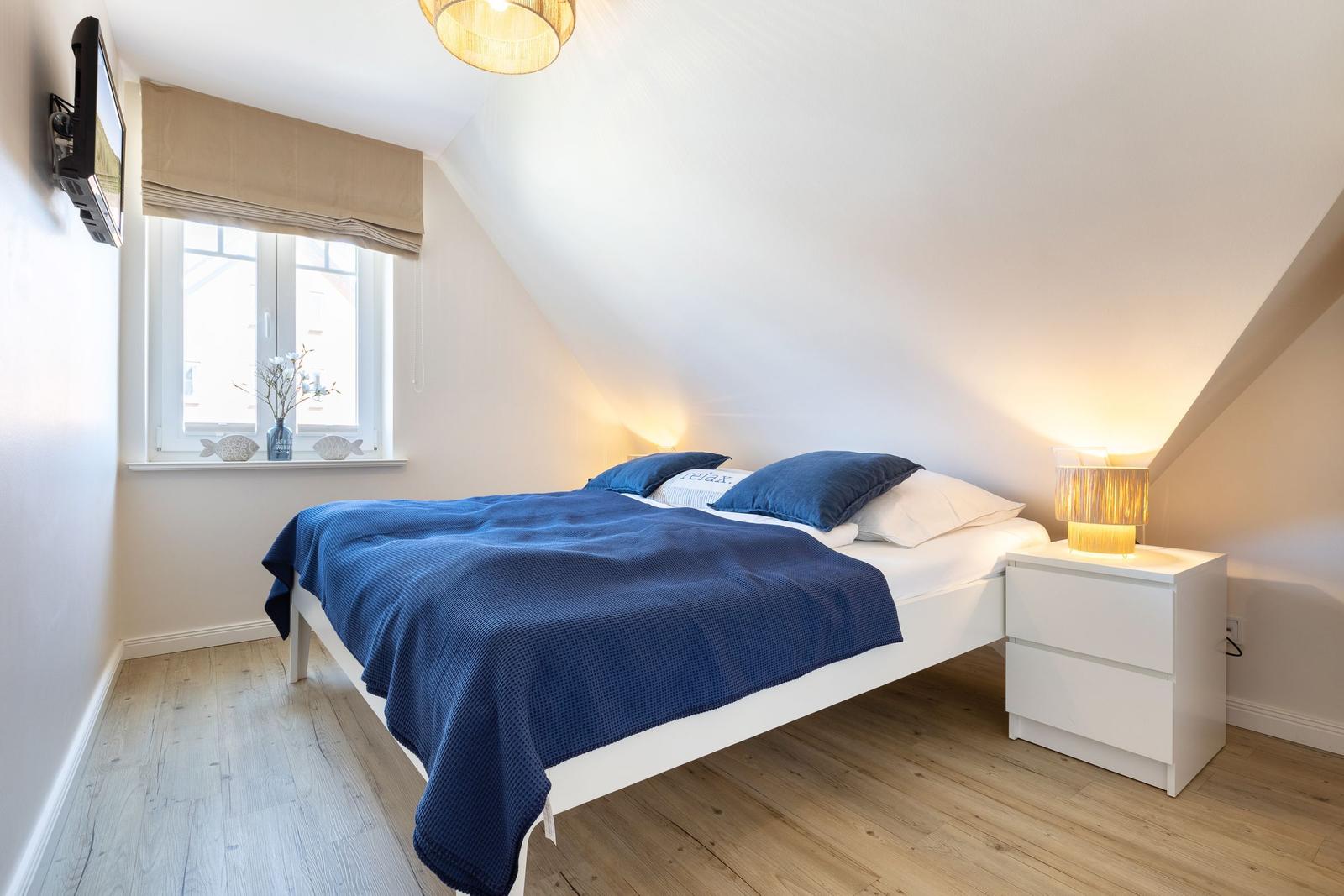 Bedroom with bed, nightstand, and window