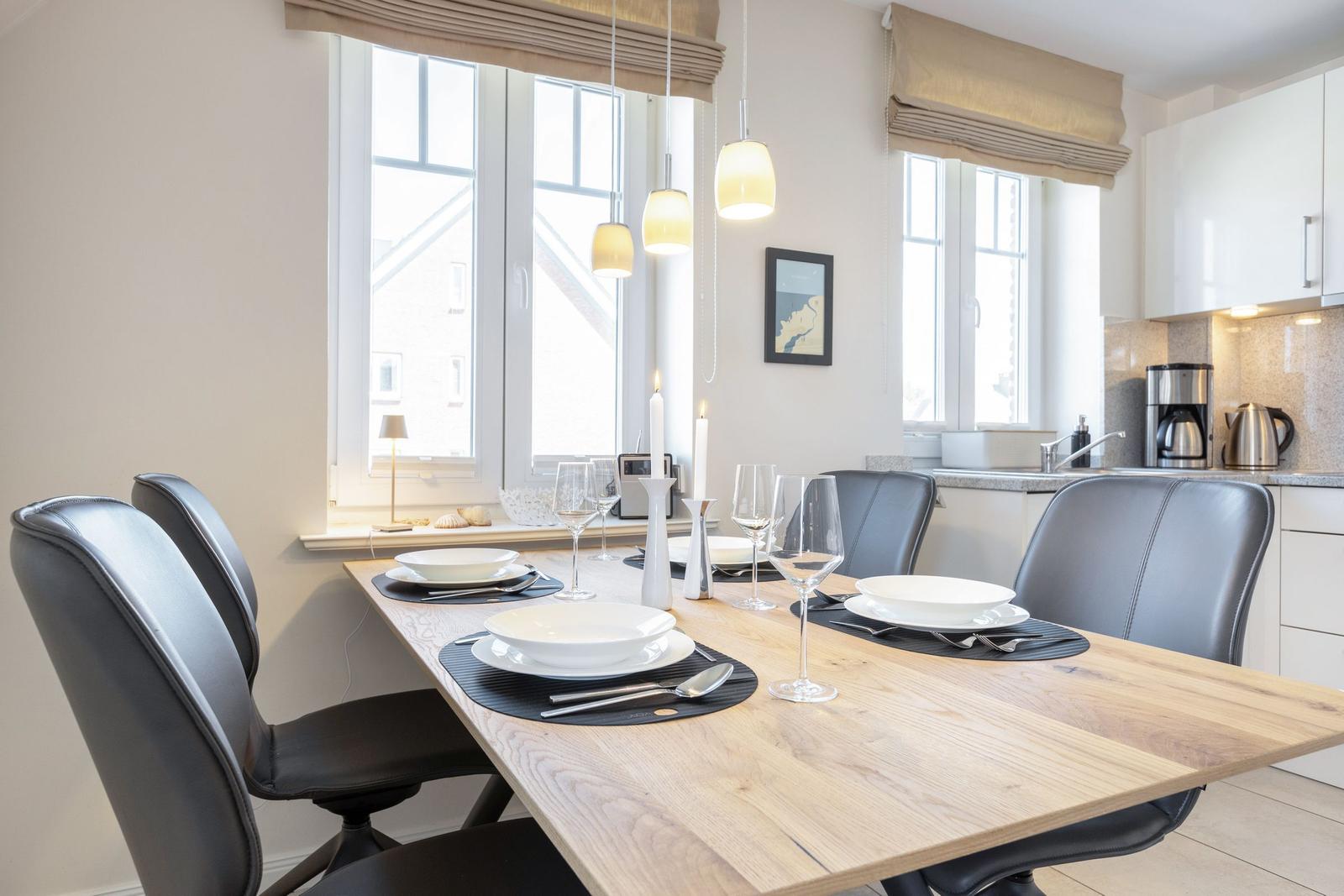Dining area with wooden table, black chairs, and windows with blinds.