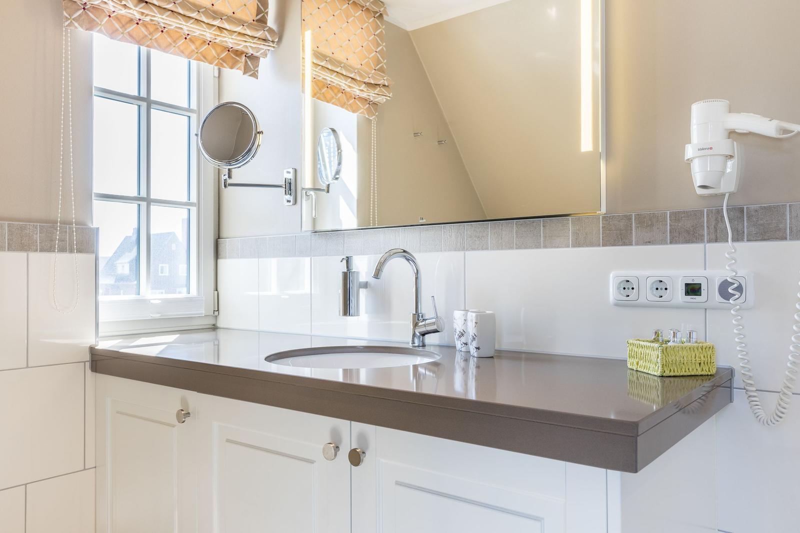 Bathroom with sink, mirror, and window