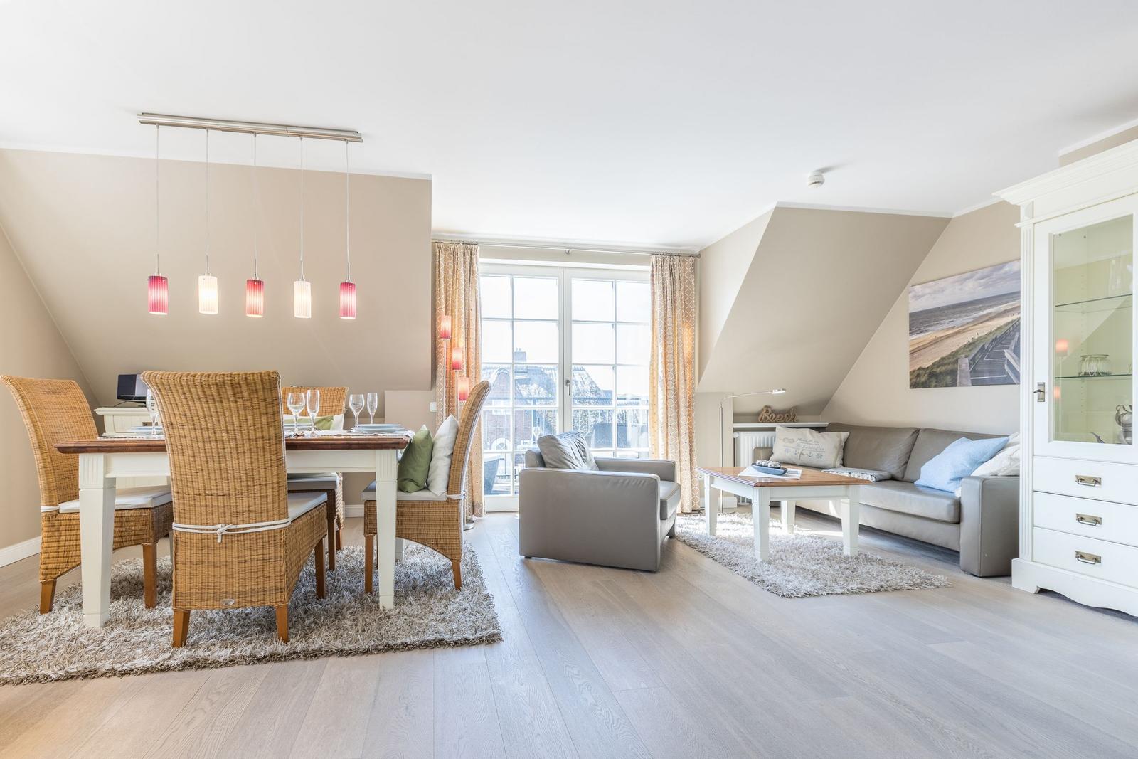 Living and dining area with sofa, dining table, and glass cabinet.
