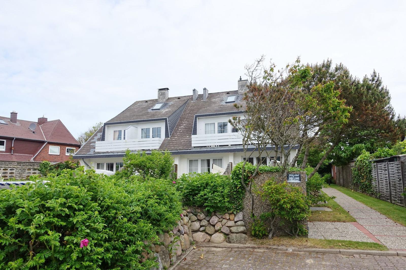 White villa with dormers and garden path