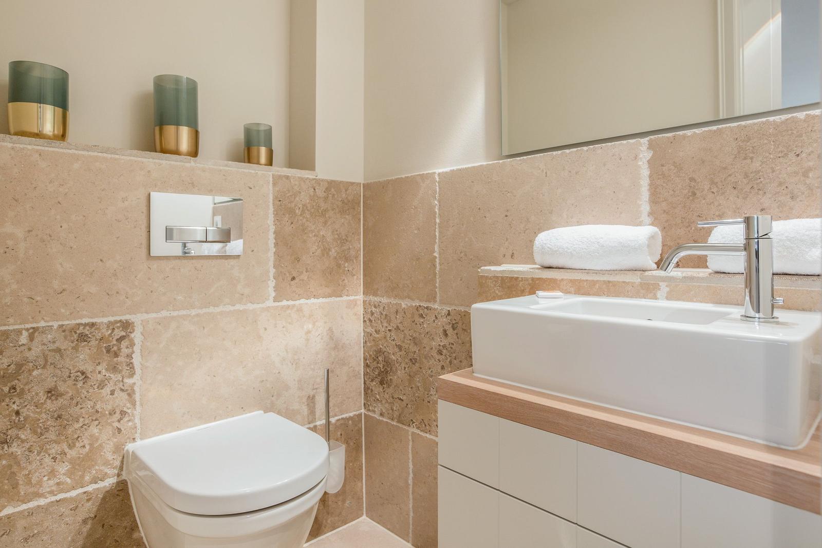 Bathroom with toilet, sink, and towel