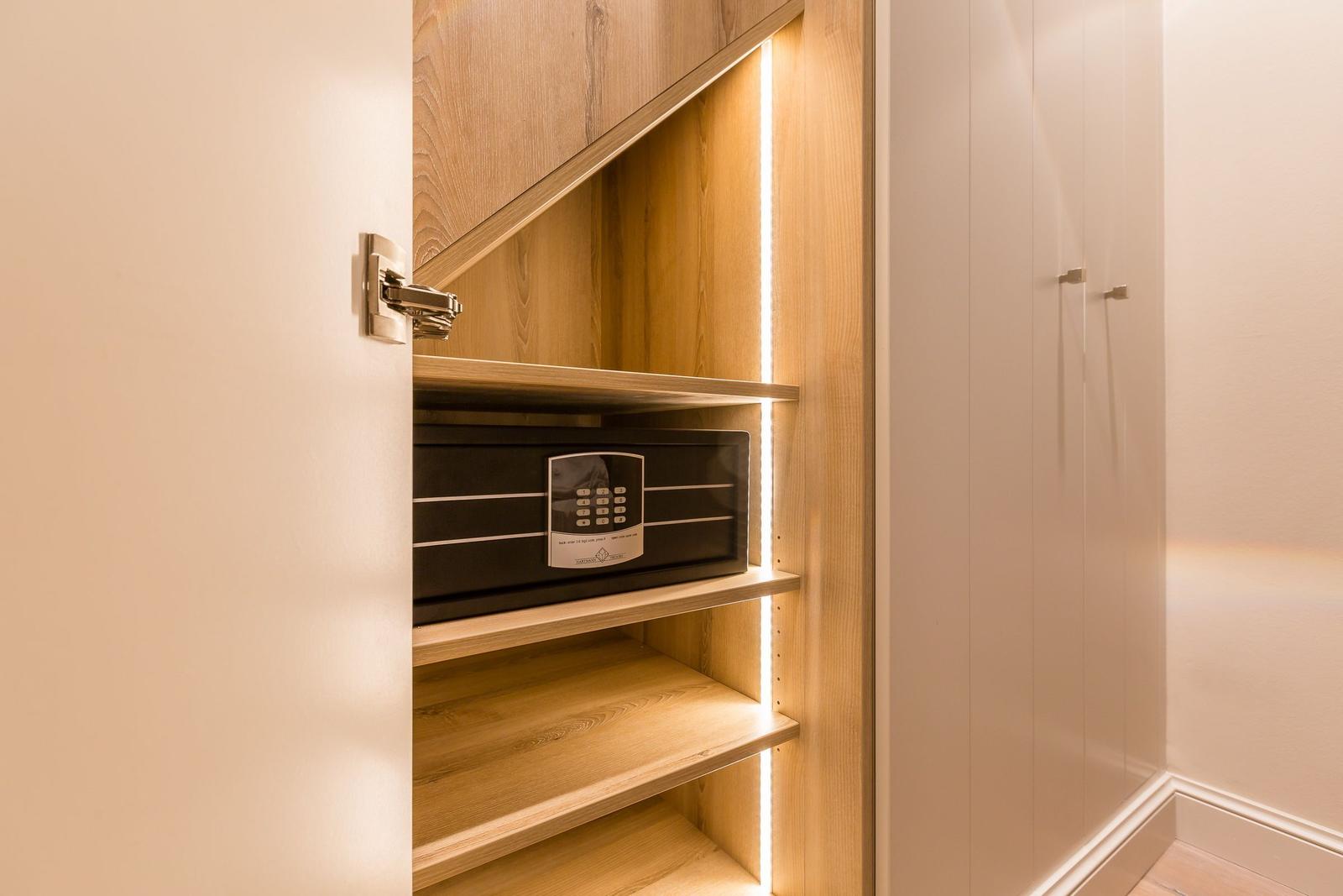 Cabinet with built-in safe and LED lighting.