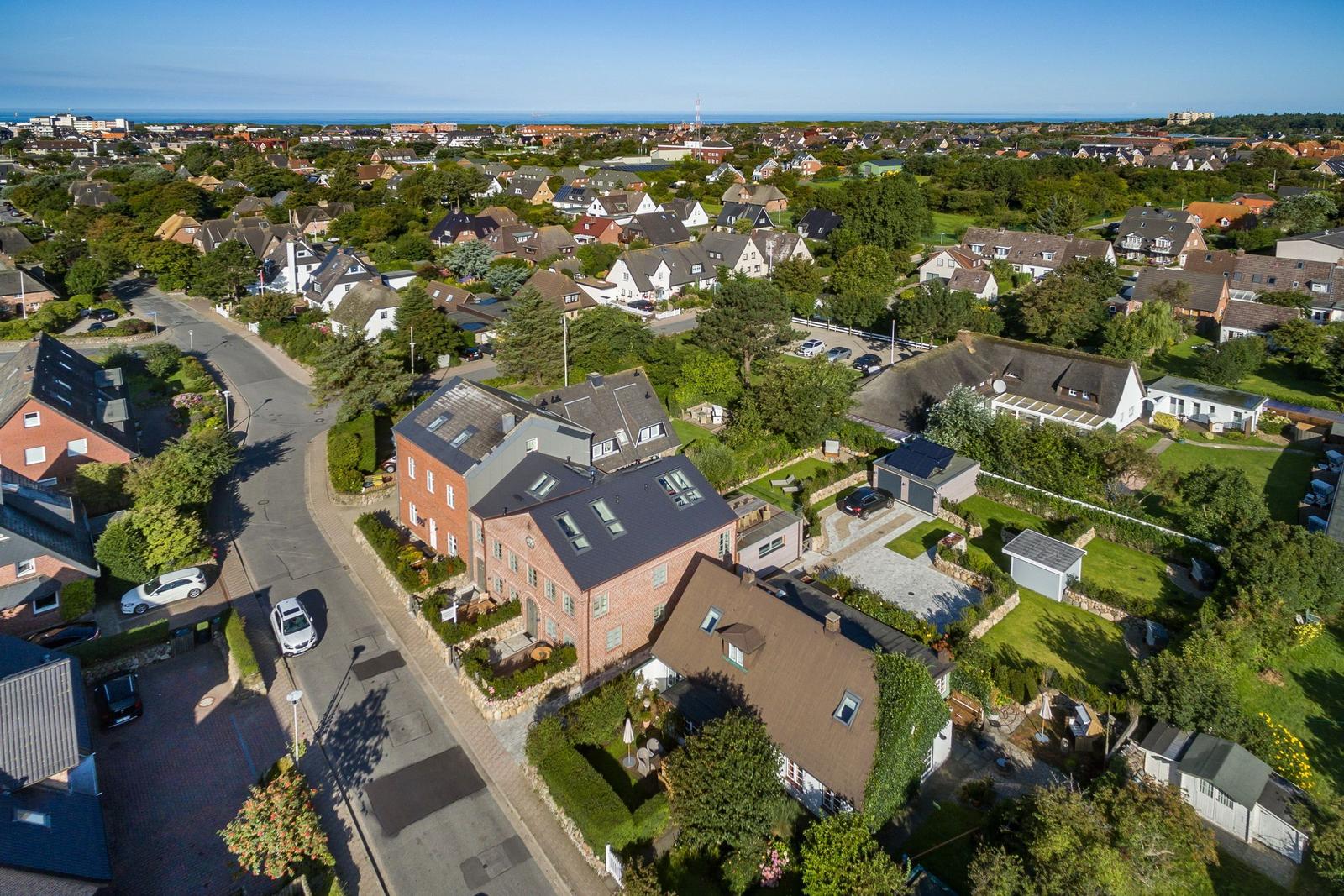 House with garden and view of coastal town