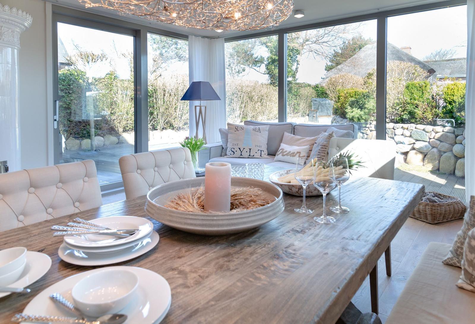 Dining area with wooden table, chairs, and garden view