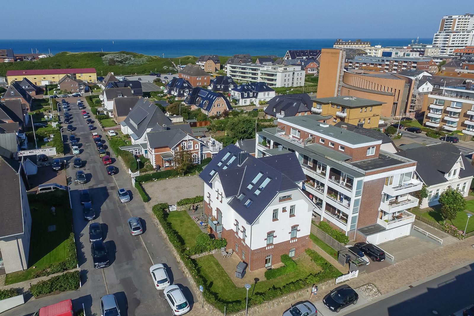 Town street with houses and view of the sea