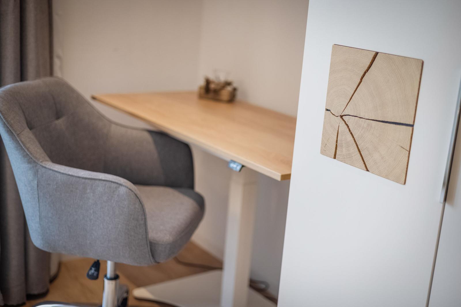 Schreibtisch mit Stuhl und Wanddekoration aus Holzquerschnitt