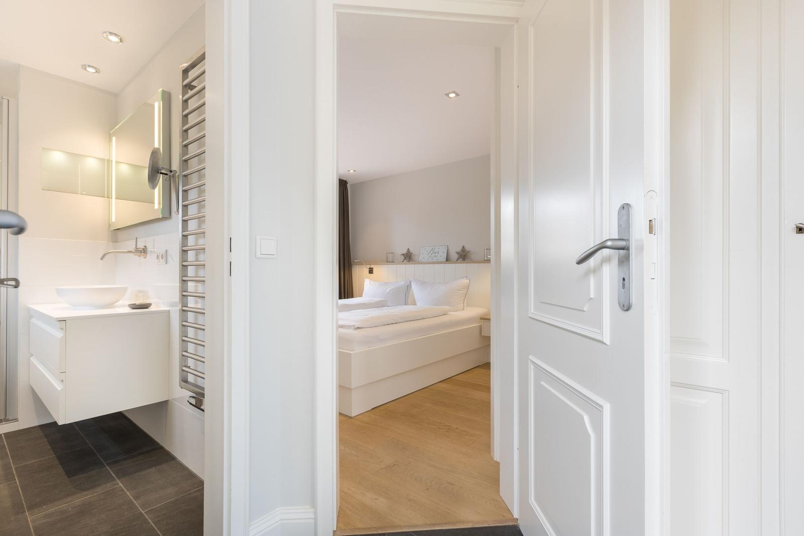 Bedroom with bed and bathroom in view