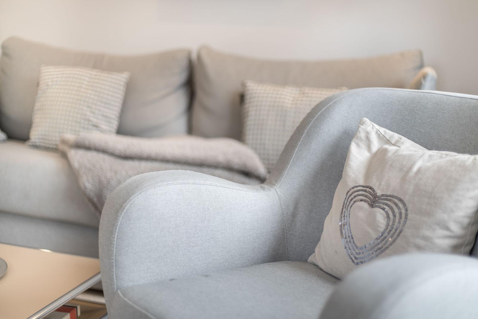 Gray seating area with cushions and blanket in living space