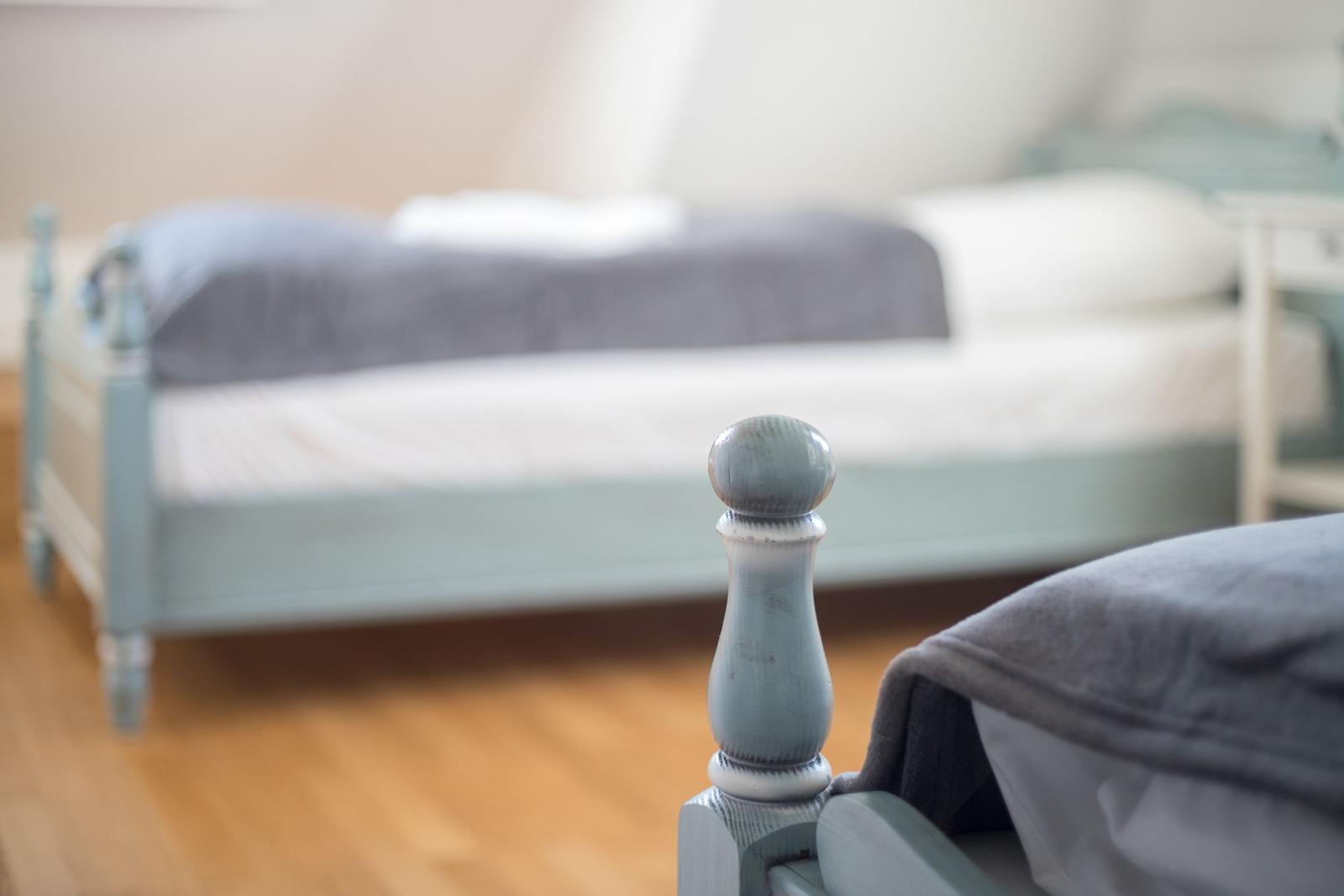 Bedroom with bed and wooden floor