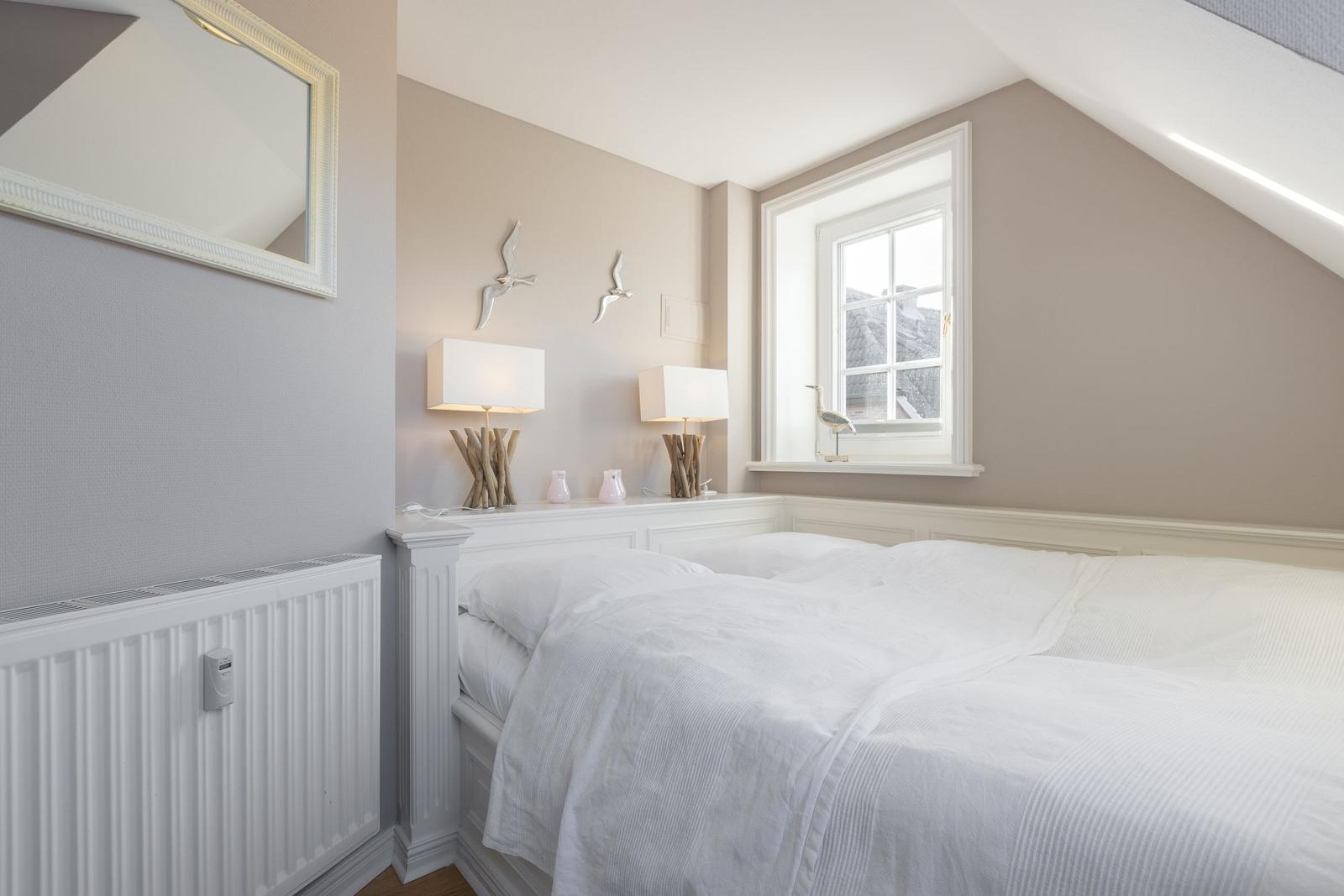 Bedroom with double bed, window, and lamps