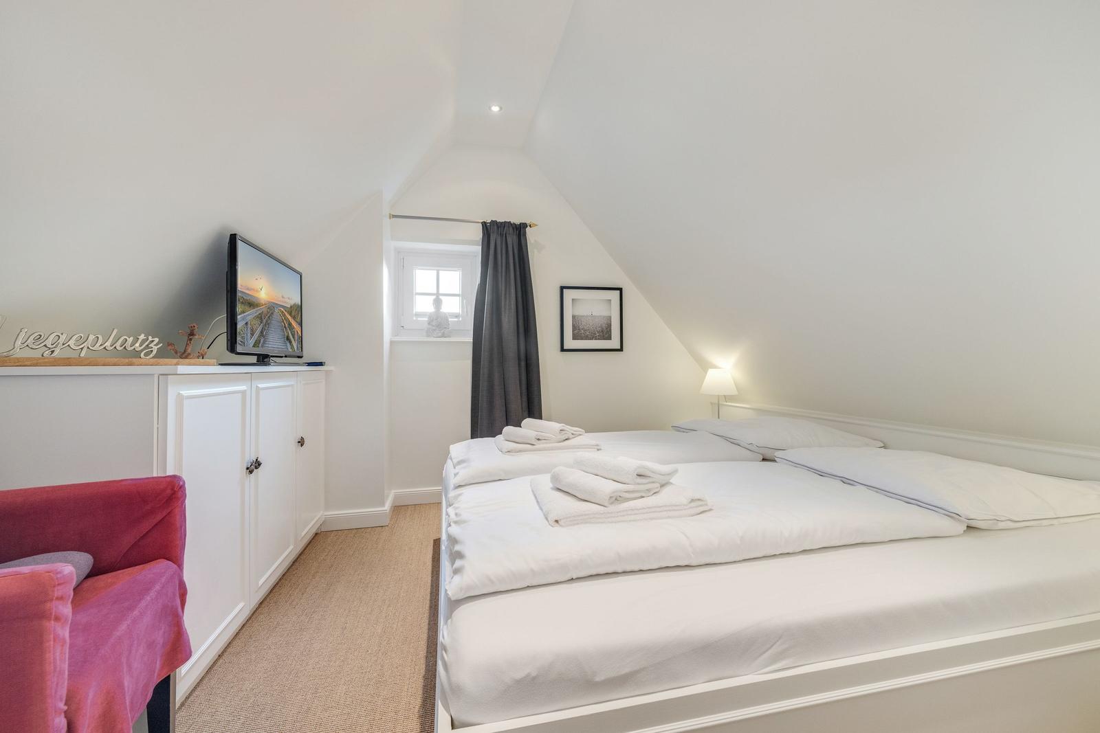 Bedroom with double bed, TV, and window