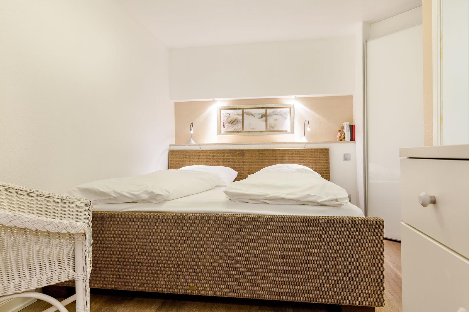 Bedroom with bed, nightstand, and closet.