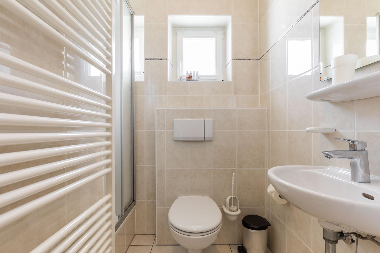 Badezimmer mit Toilette, Waschbecken und Dusche