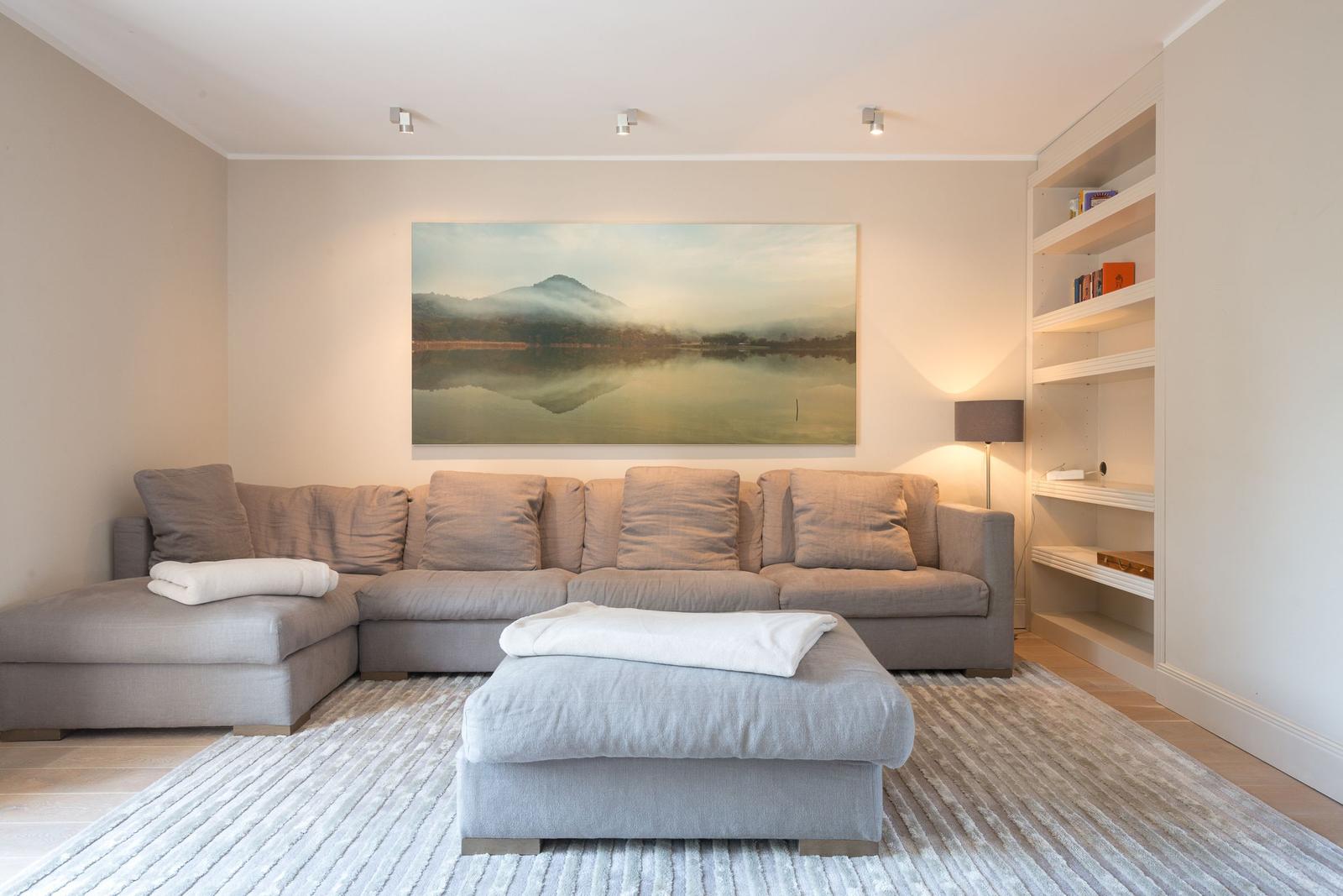 Living room with sofa, rug, and wall art