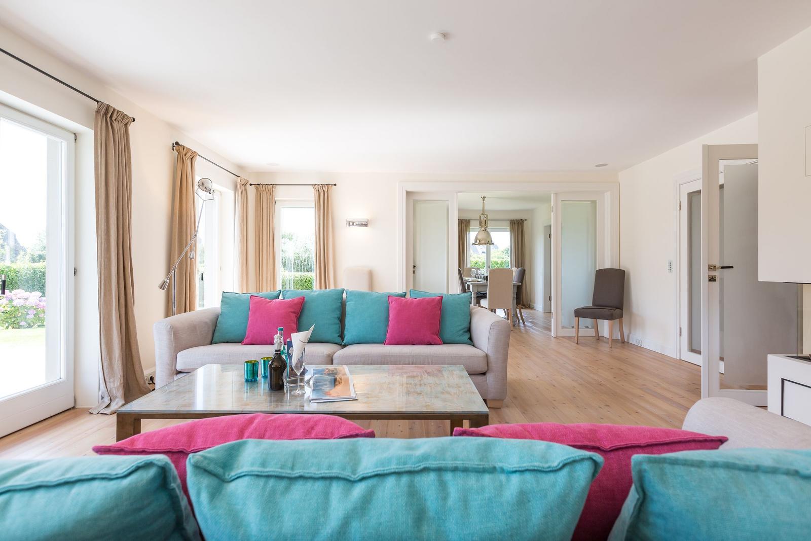 Living room with sofa, coffee table, and garden view