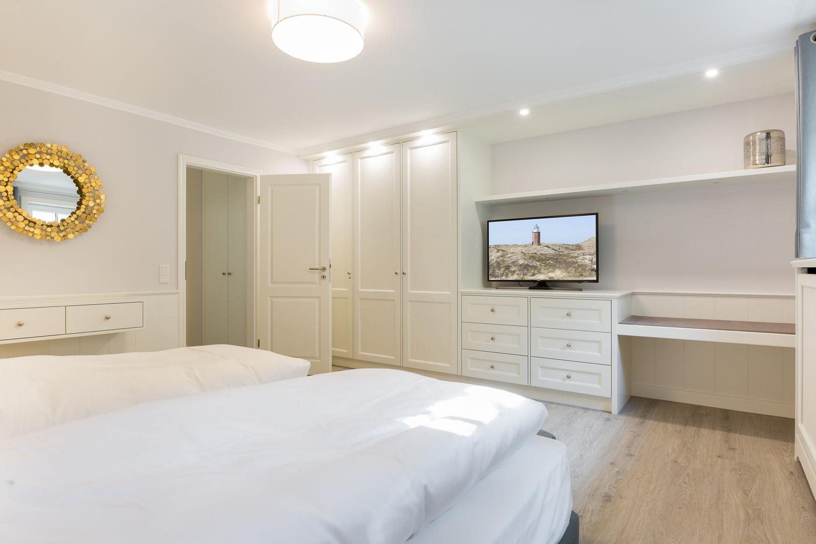 Bedroom with bed, wardrobe, and TV furniture