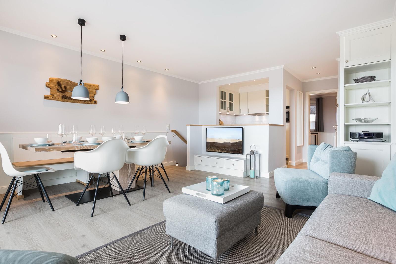 Living and dining area with sofa, dining table, and TV.