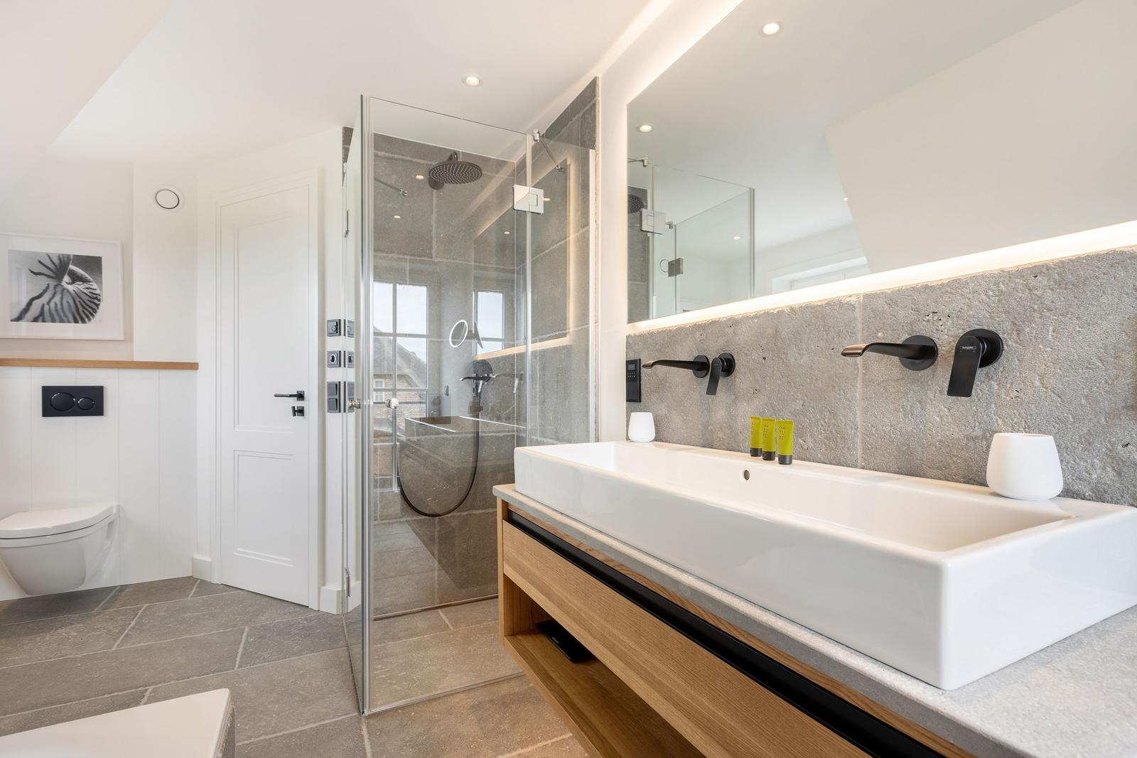 Bathroom with shower, sink, and toilet