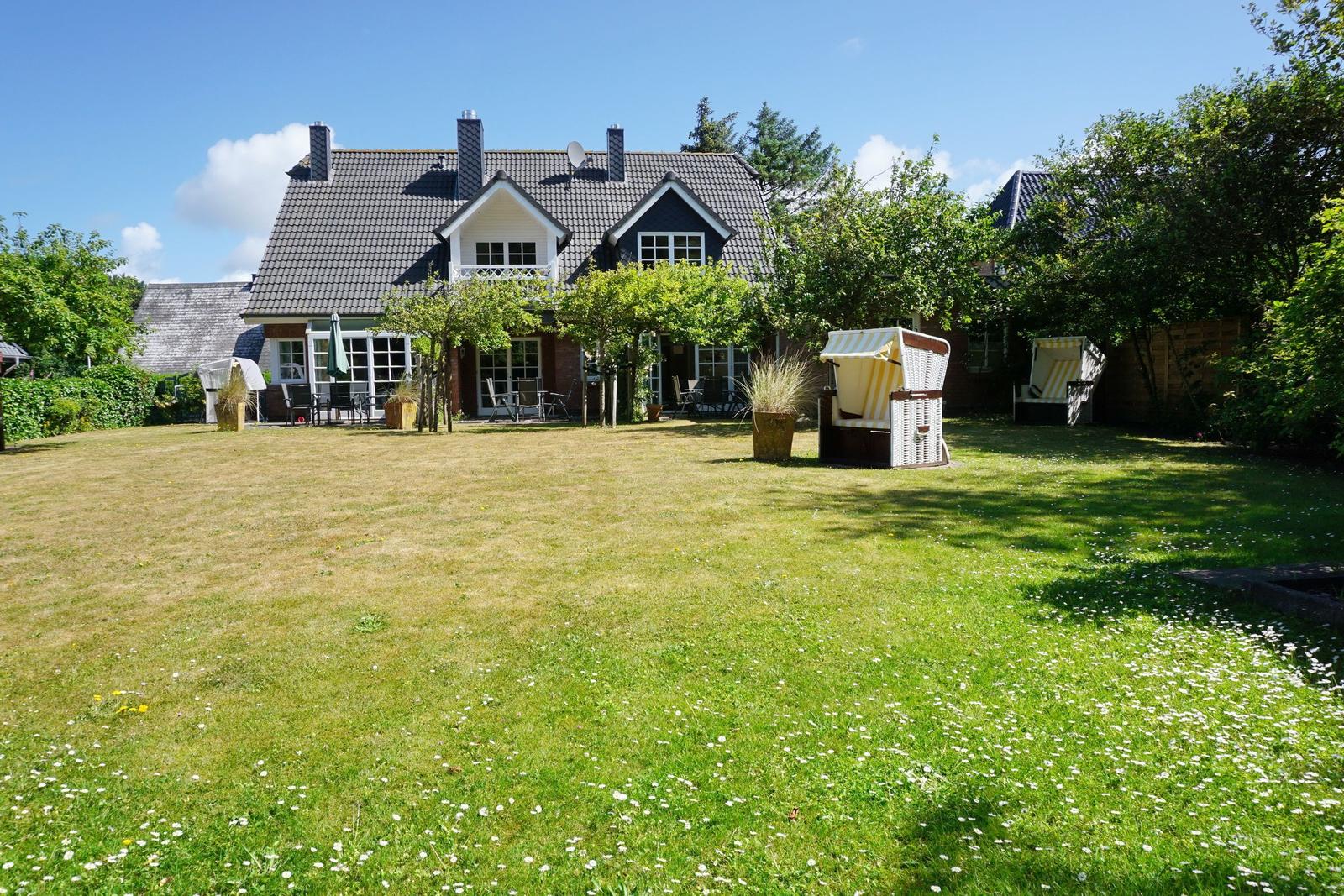 House with large garden and beach chairs