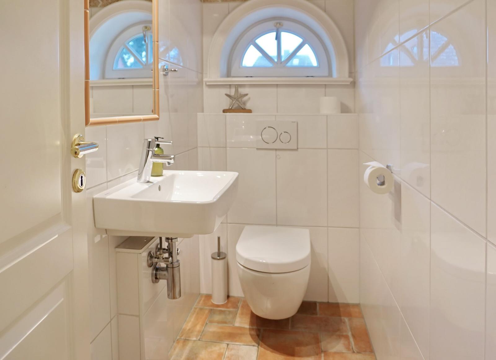Bathroom with toilet, sink, and bathroom window.