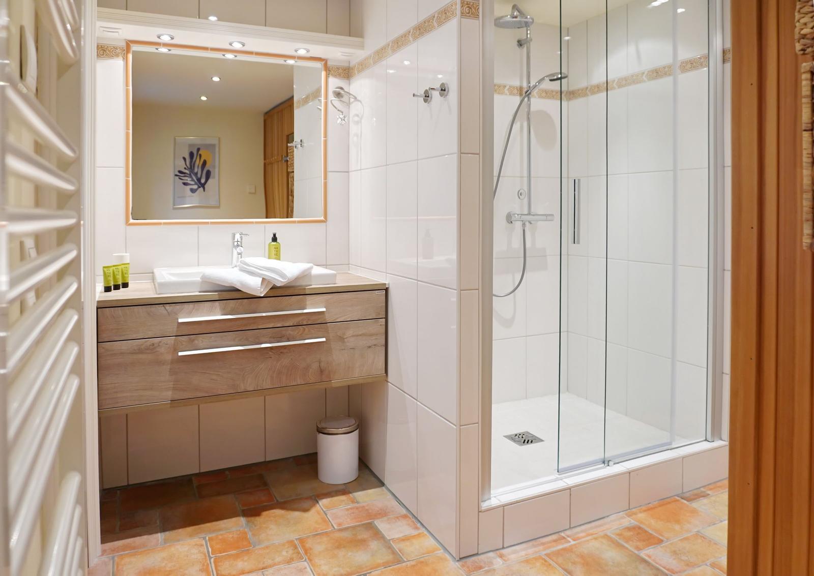 Bathroom with shower, sink, and mirror