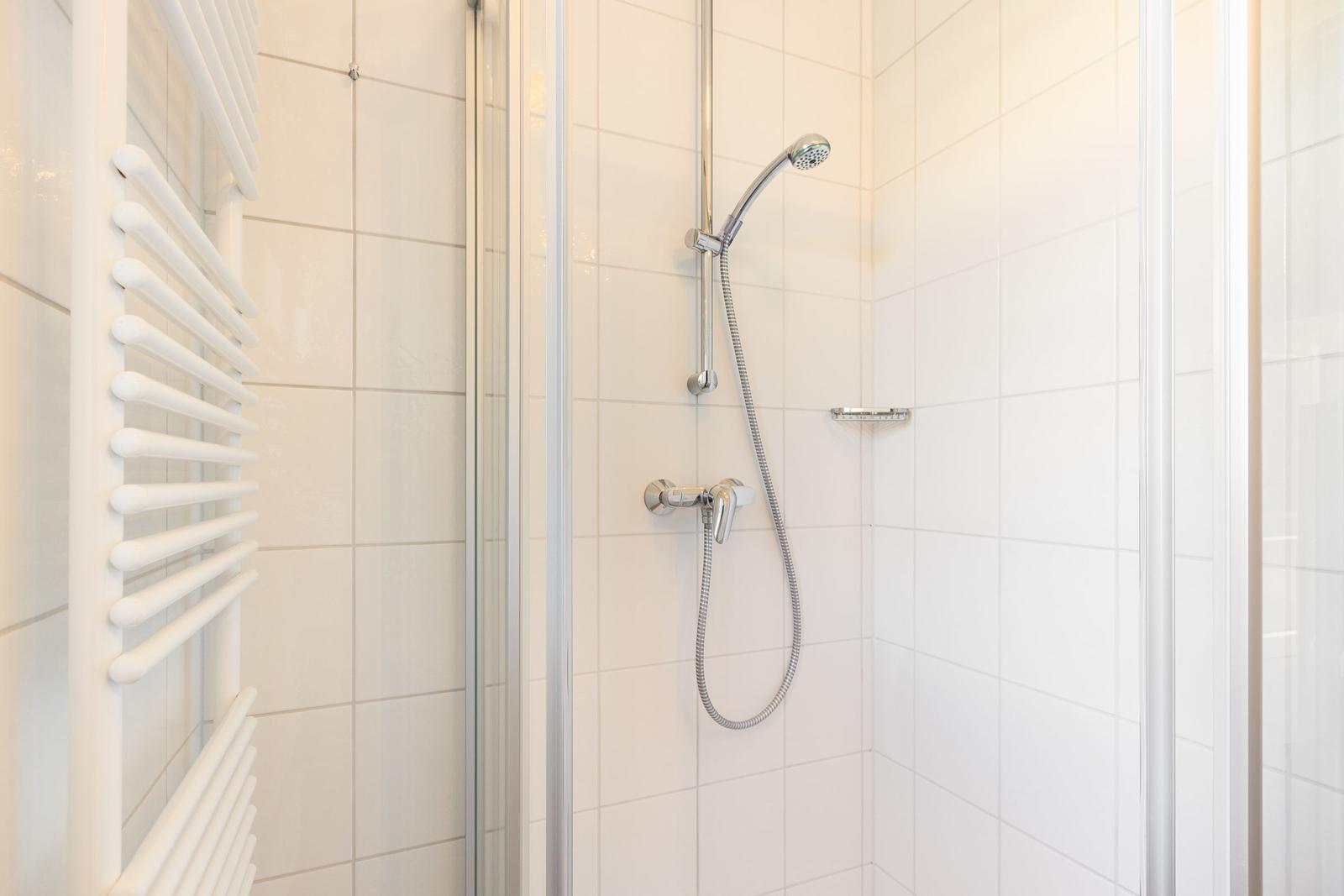 Shower with showerhead and radiator on the wall
