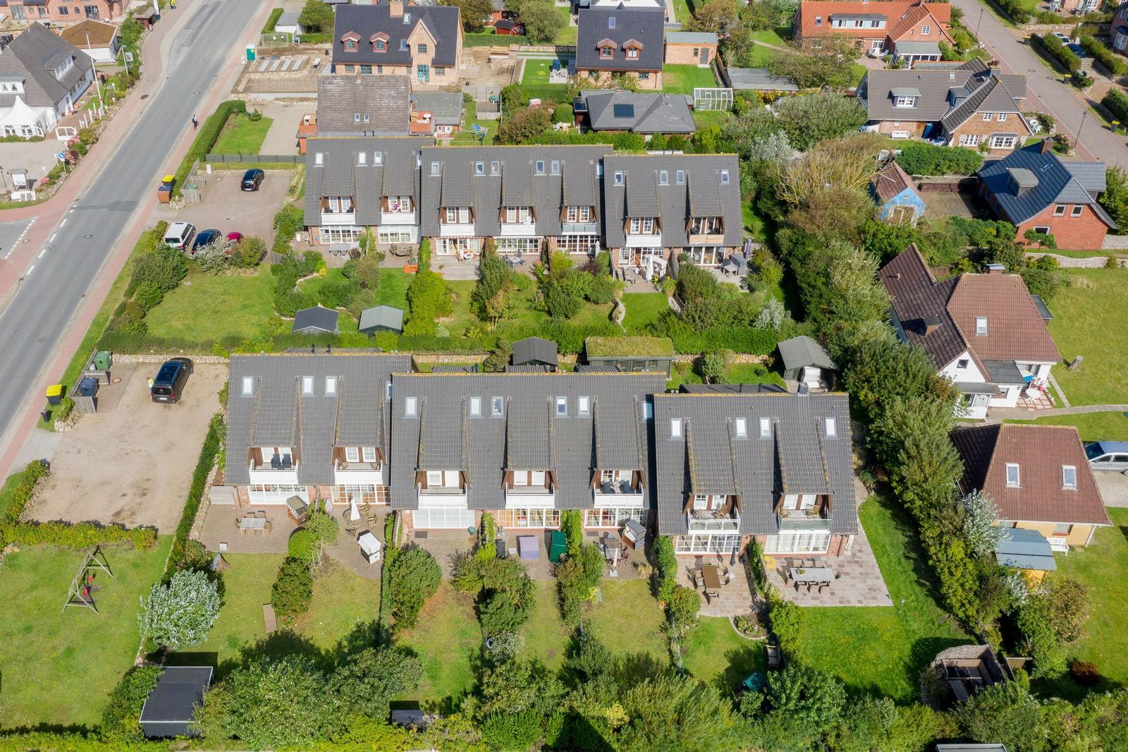 House with multiple apartments and large gardens in a quiet residential area.