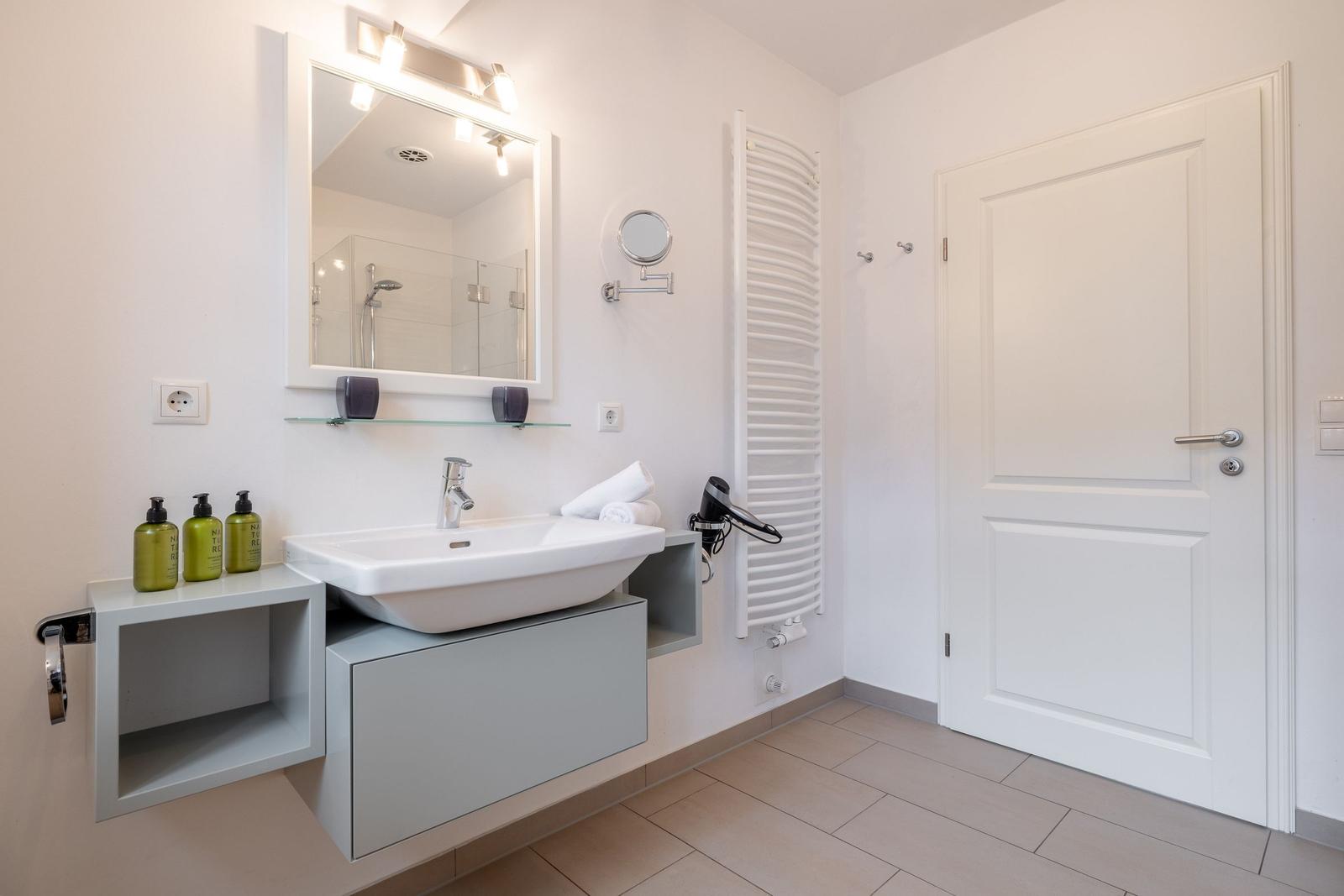 Bathroom with sink, mirror, and shower