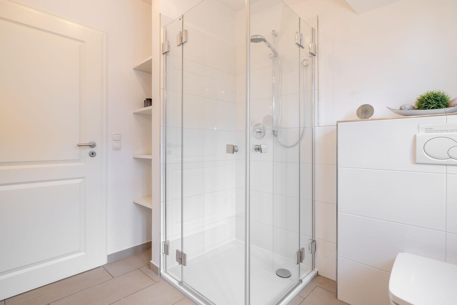 Bathroom with shower, toilet, and shelf