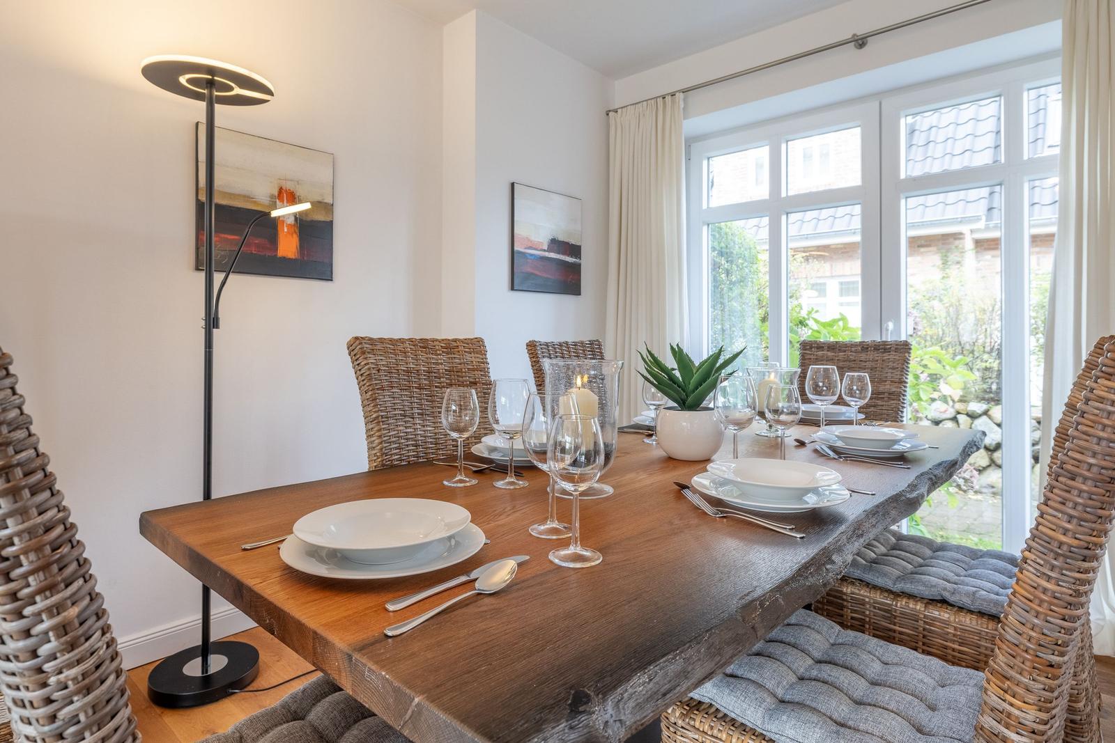 Dining room with wooden table, chairs, and window view