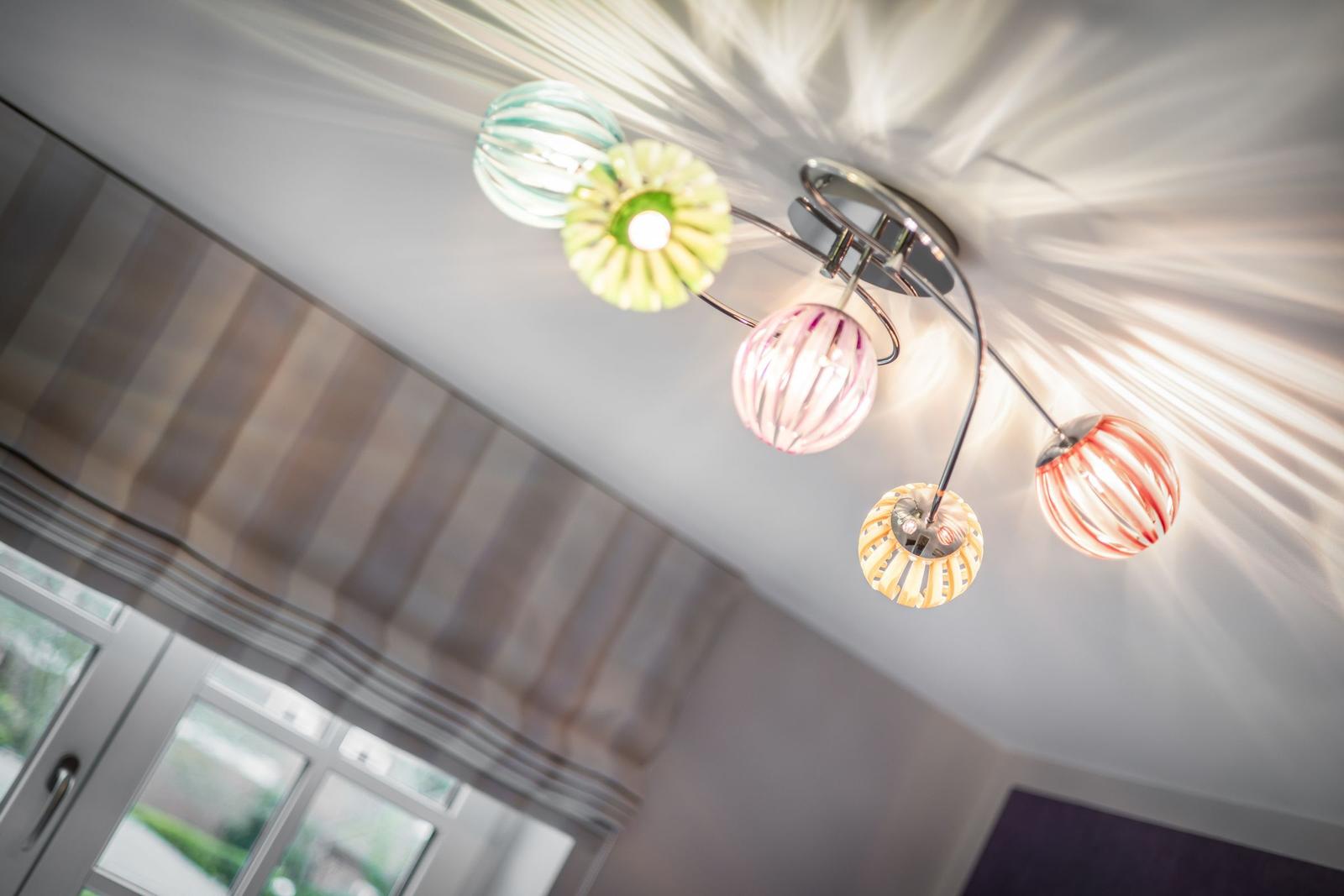 Ceiling light with colorful glass globes and striped pattern.