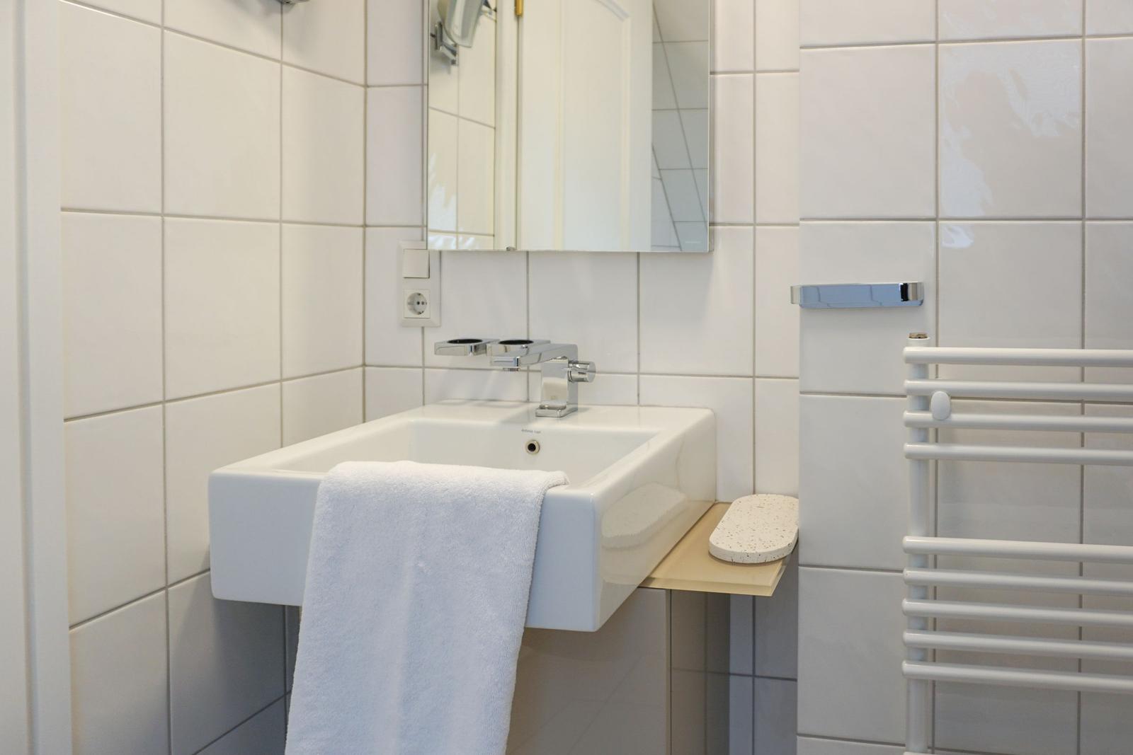 Bathroom with sink, mirror, and towel rack