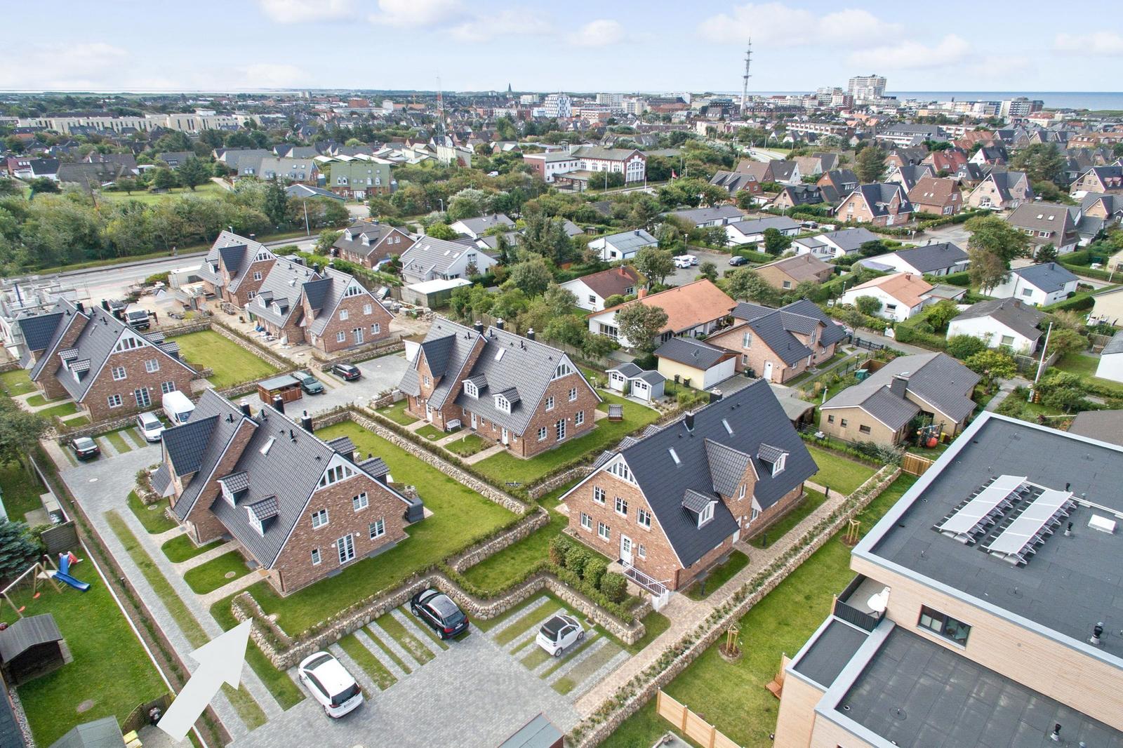 Aerial view of houses with gardens and streets in a town