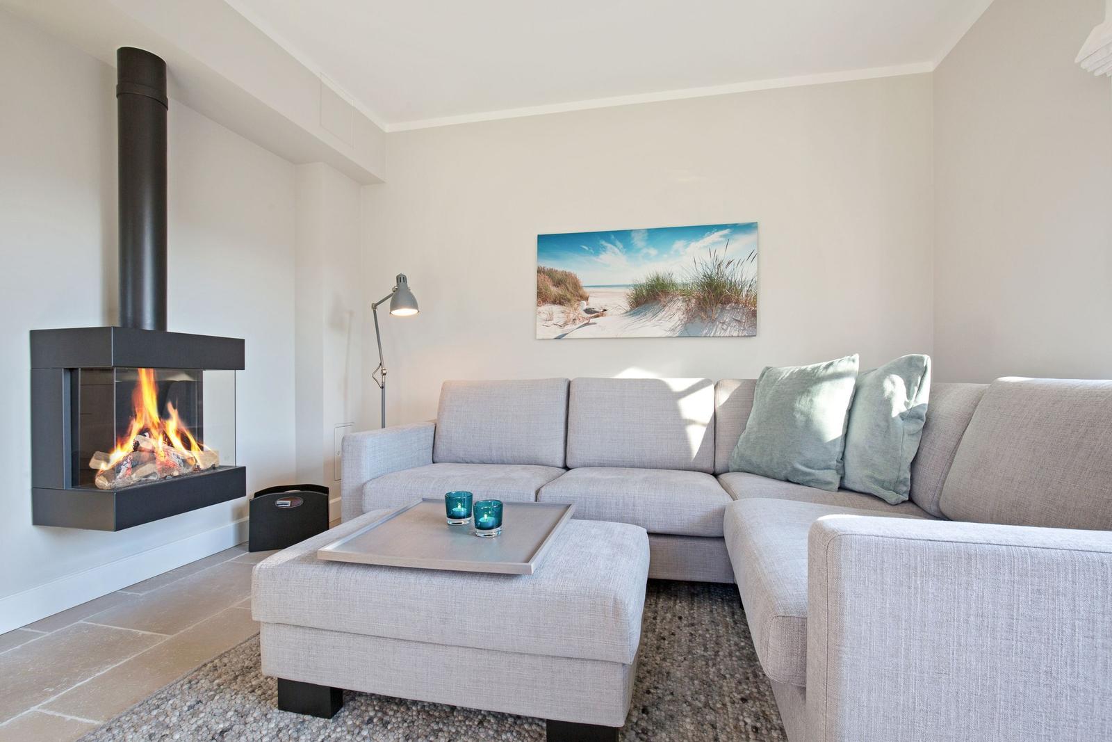 Living room with sofa, fireplace, and wall art